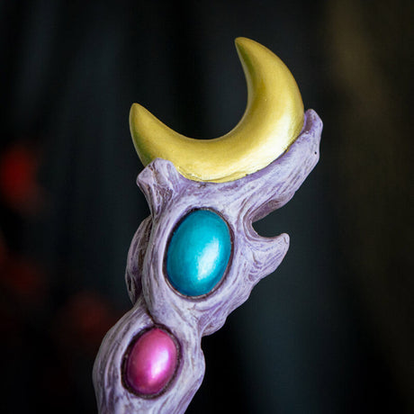 Magic wand in pale purple with orbs in gold, blue and pink with golden crescent moon topper