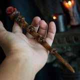 Magic wand with brown skull staff and faux red crystal topper