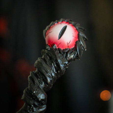 Magic wand with black staff and red dragon eye at the top.