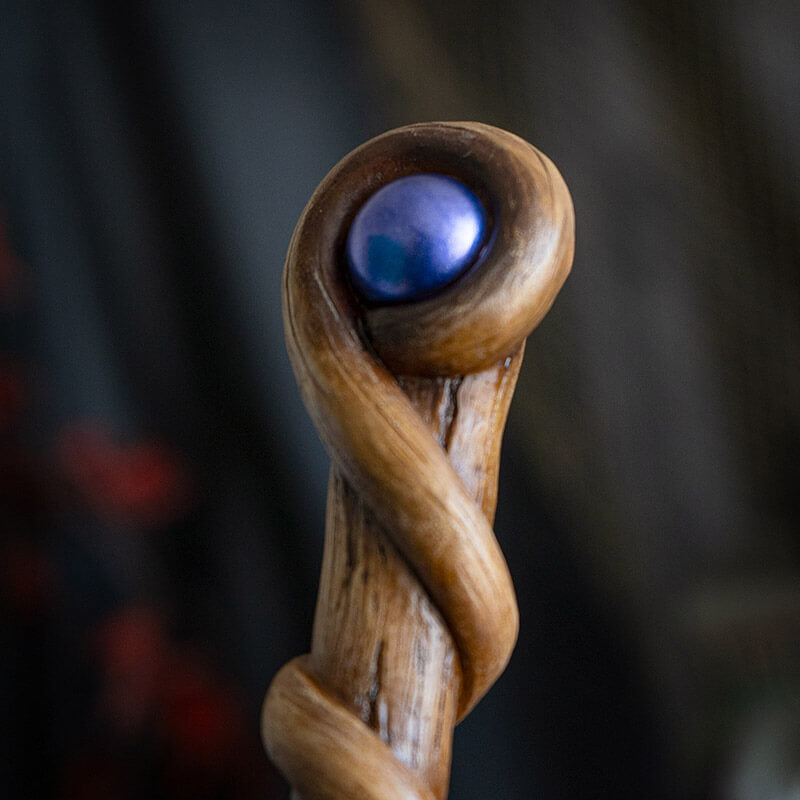 Magic wand with swirling faux-wood staff and blue orb at the top