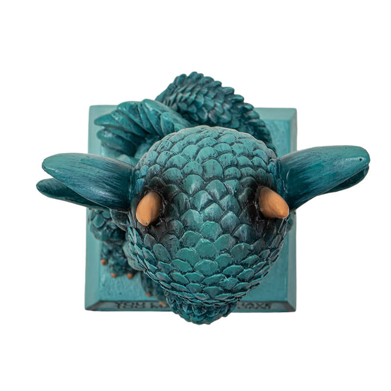 Cyan blue dragon figurine with flame sitting on a base that reads "You can never have too many dragons!" Top down view