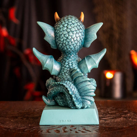 Cyan blue dragon figurine with flame sitting on a base that reads "You can never have too many dragons!" Shown from the back