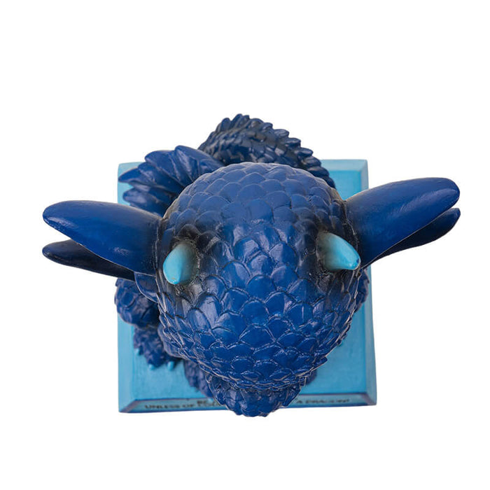 Figurine of a dragon sitting on a blue base that says "BE YOURSELF ALWAYS UNLESS OF COURSE YOU CAN BE A DRAGON!" The dragon is shades of blue with a little burst of fire. Top down view