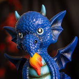 Figurine of a dragon sitting on a blue base that says "BE YOURSELF ALWAYS UNLESS OF COURSE YOU CAN BE A DRAGON!" The dragon is shades of blue with a little burst of fire.