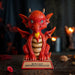 Figurine of a red dragon on a tan base that reads "W.W.A.D.D.? What Would A Dragon Do?" 