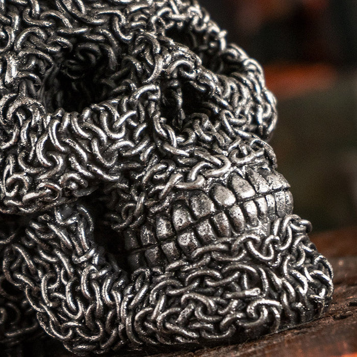 Skull figurine appearing to be made of chains in faux-silver