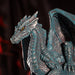 Figurine of a blue dragon on the planet Uranus with golden eyes