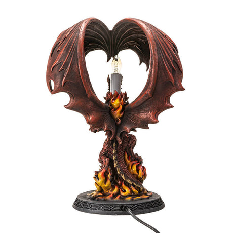 Corded lamp with red dragon with fire on a Celtic base, lightbulb in the back below curled wings.