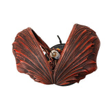 Corded lamp with red dragon with fire on a Celtic base, lightbulb in the back below curled wings. Top down view