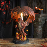 Corded lamp with red dragon with fire on a Celtic base, lightbulb in the back below curled wings.