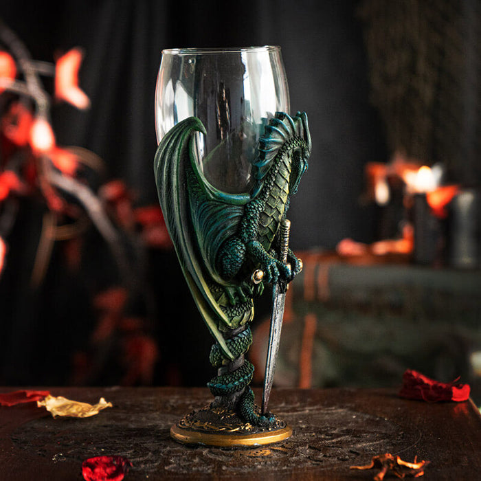 Glass topped goblet with green dragon and sword making up the stem