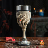 Goblet with stainless steel drinking insert. Skeletal hands hold four cards, showing both the backs and the aces on a poker-themed base.