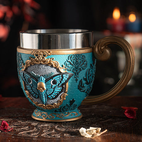 Teacup with blue moth and faux-gold filigree, stainless steel insert