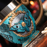 Teacup with blue moth and faux-gold filigree, stainless steel insert