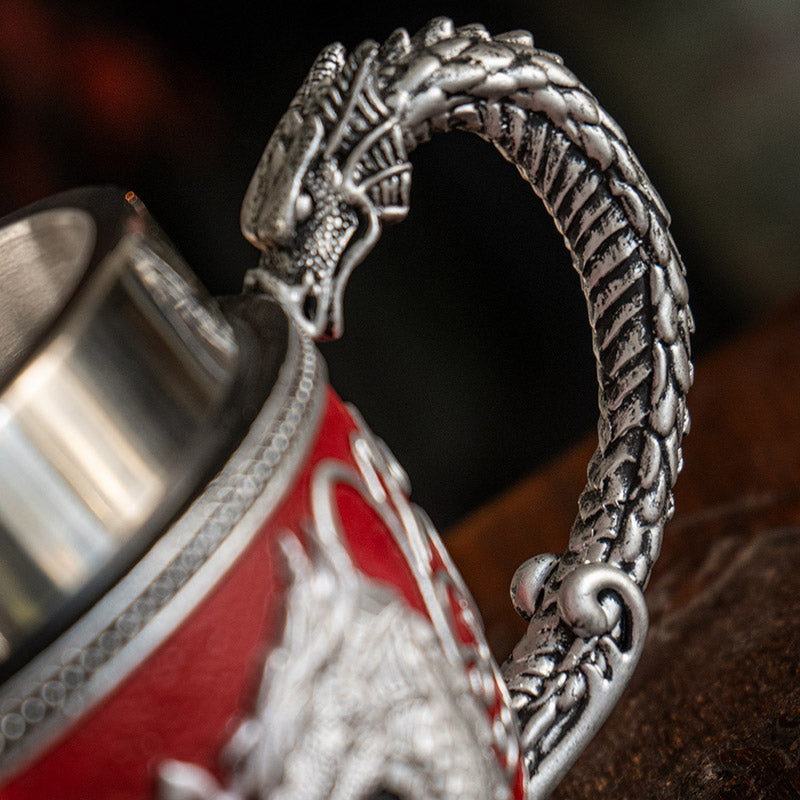 Teacup with stainless steel insert. Dragons in silver forming a heart on red background, swirls and crimson heart jewels.