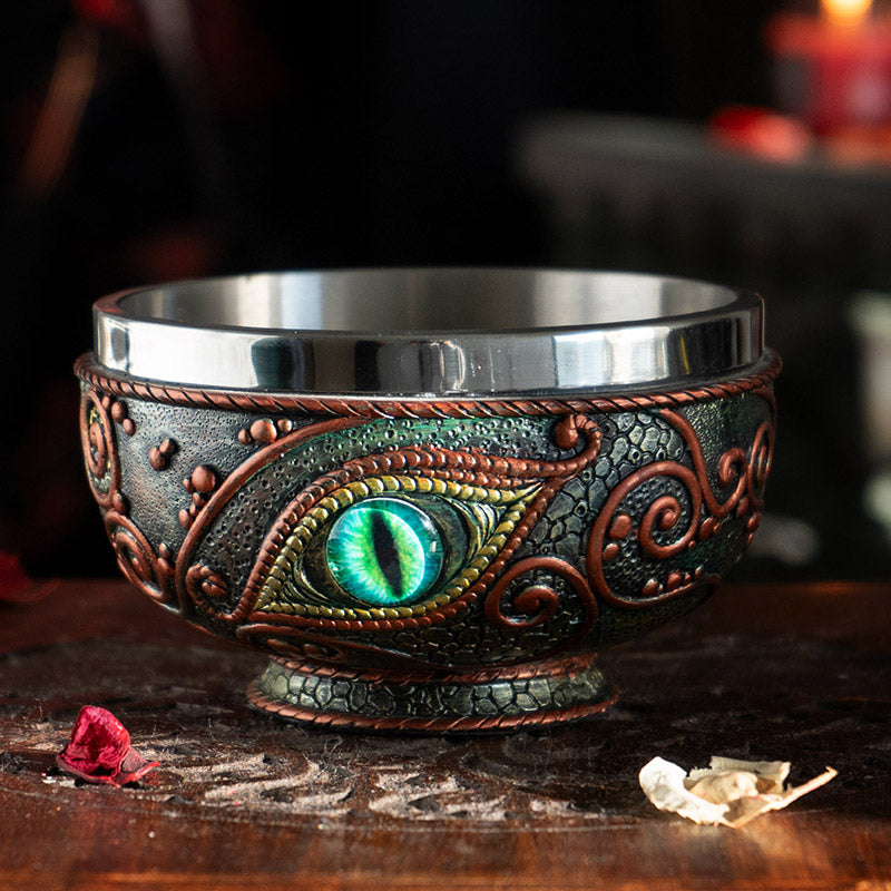 Bowl with aqua dragon eye design, red accents on black, and stainless steel insert