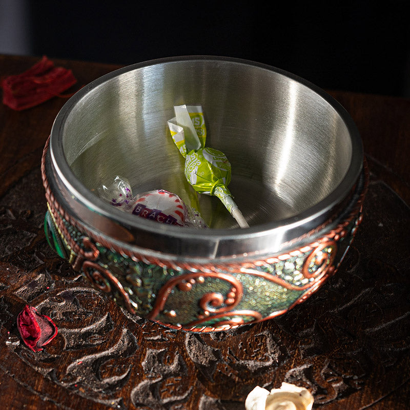 Bowl with aqua dragon eye design, red accents on black, and stainless steel insert