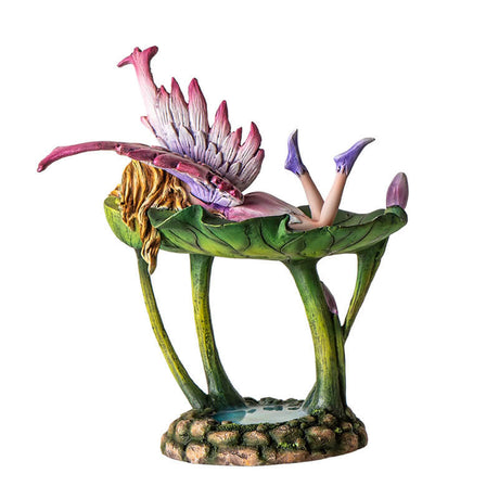 Figurine jewelry dish tray with raised lotus leaf above a pond. Fairy in pink and purple with winged frog on the leaf-dish