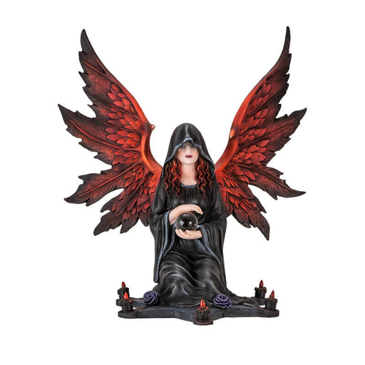 Figurine of an angel with red wings and hair in a black cloak, holding a crystal ball sitting at the center of a star with purple roses and candles