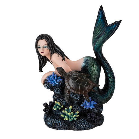 Figurine of black haired mermaid with green and blue tail resting on coral reef with a dark sea turtle