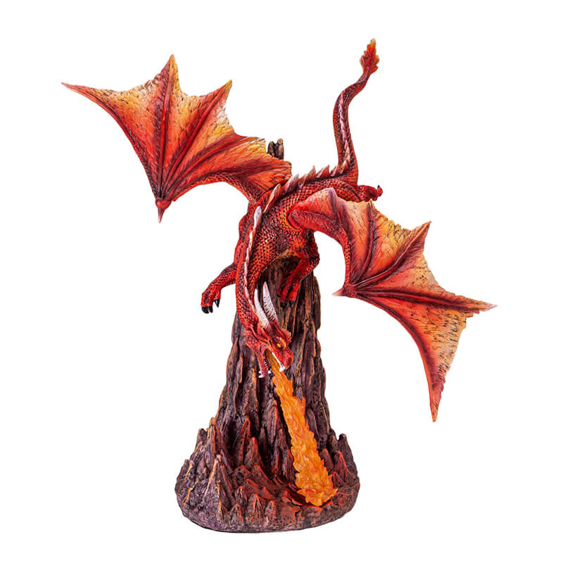 Figurine of a red dragon flying over rocks, breathing a column of orange fire