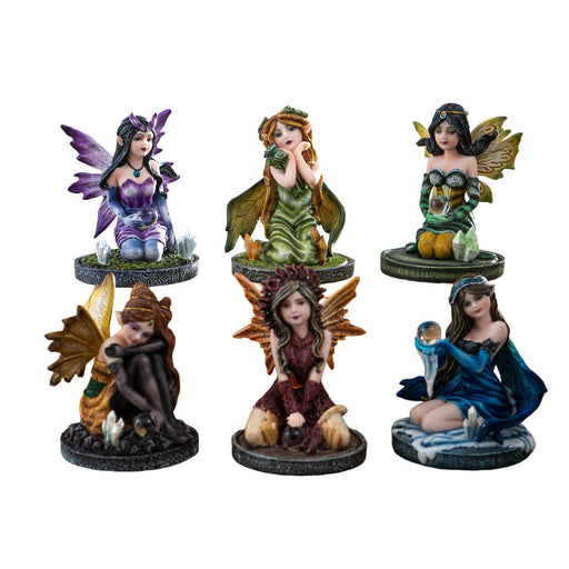 Set of 6 fairy figurines in purple, greens, reds, and blue, most holding crystal balls, one with flowers
