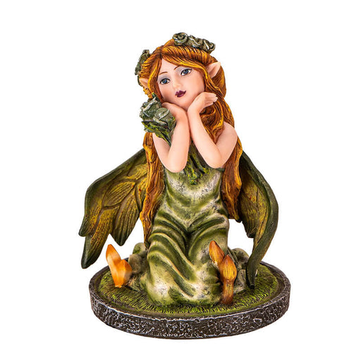 Figurine of small fairy with crystals and mushrooms where she kneels in the moss, holding a bouquet of flowers with more in her blond hair.