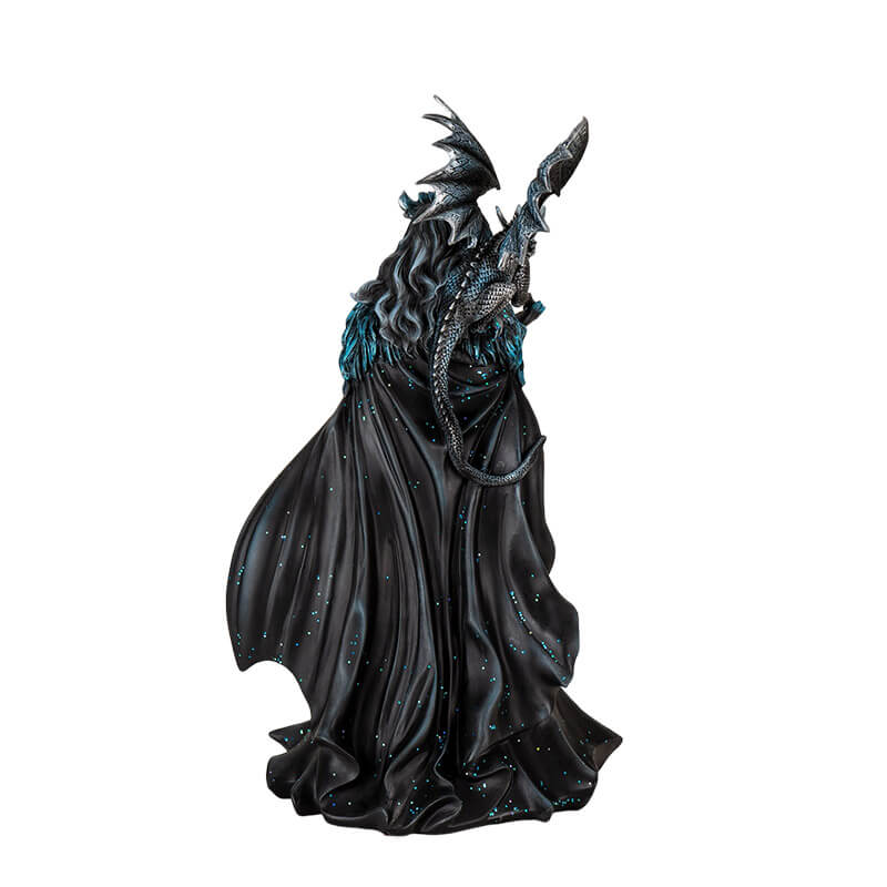 Figurine of a woman in black and blue dress with glitter and flowing cape, and a black and blue dragon on her shoulder.