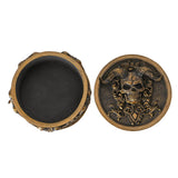 Trinket box with gold horned skulls on black background