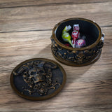 Trinket box with gold horned skulls on black background