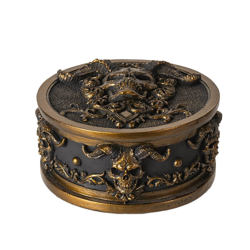 Trinket box with gold horned skulls on black background