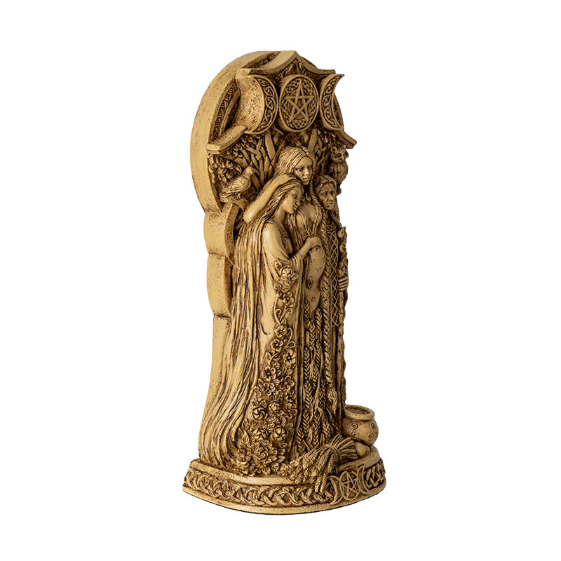 Faux-stone figurine in ivory color with triple goddess - maiden, mother, and crone standing together under a triple moon design - waxing, full and waning. At their feat is a cauldron and sheaf of wheat.