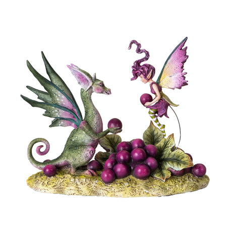 Figurine of green dragon and purple fairy sharing a pile of purple grapes