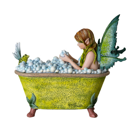 Figurine by Amy Brown, green-winged fairy sits in bubble bath (yellow tub) with a winged frog perched on the edge