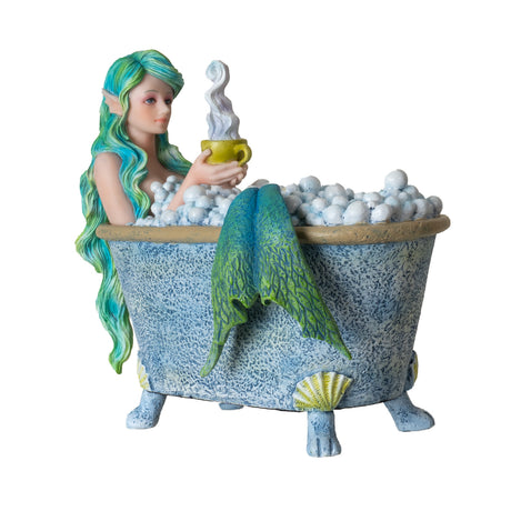 Figurine by Amy Brown of mermaid with green hair and tale in seashell-adorned bathtub full of bubbles, holding steaming yellow mug