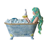 Figurine by Amy Brown of mermaid with green hair and tale in seashell-adorned bathtub full of bubbles, holding steaming yellow mug