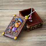 Tarot-sized trinket box with mushrooms in different colors on the lid and around the outside