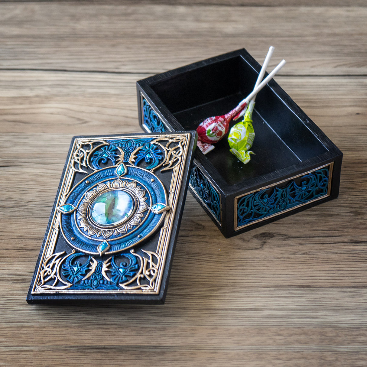 Trinket box in blue, gold, black color scheme with all seeing eye at the center of the lid