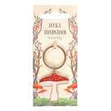 Lucky Toadstool red and white mushroom keychain on forest themed packaging