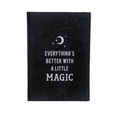 Black velvet journal with silver writing on cover: "Everything's better with a little magic"