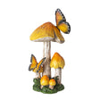 Figurine of yellow-topped mushrooms growing from grass/moss with two yellow-orange and black butterflies