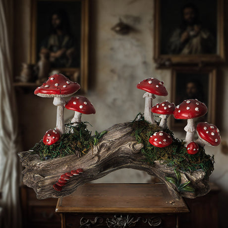 Red capped and white toadstools growing along a mossy faux=wood log stump