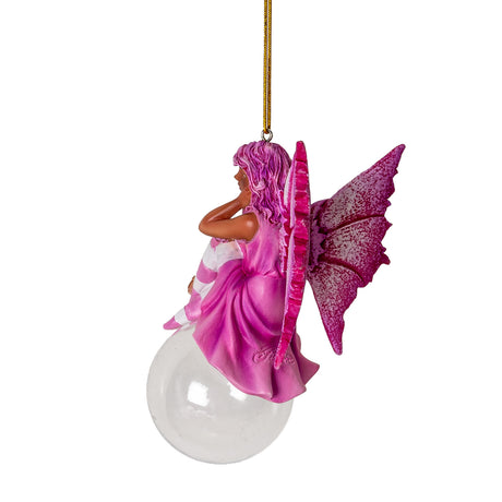 Hanging fairy ornament, dressed in pink with rose and white stockings, speckled pink wings, tan skin, perched on glass bubble