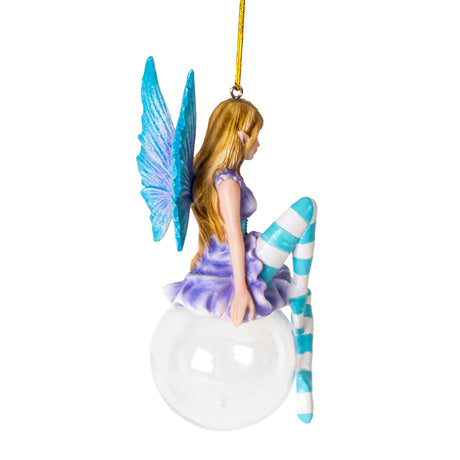 Hanging fairy ornament, pixie with dark blond hair, purple dress, blue corset, cyan wings and striped stockings perched on glass bubble