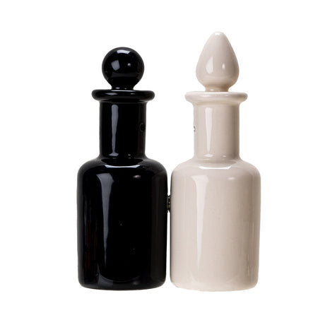 Salt and pepper shakers shaped like potion bottles. attached via magnets to one another