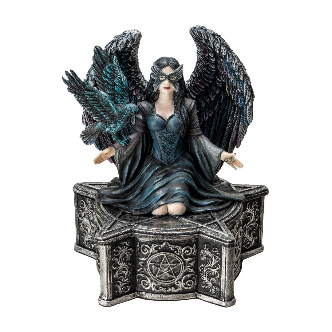 Trinket box, on the lid is a black feather winged angel with a raven on her arm, blue-black dress, black hair, mask. Base of box has pentacle designs