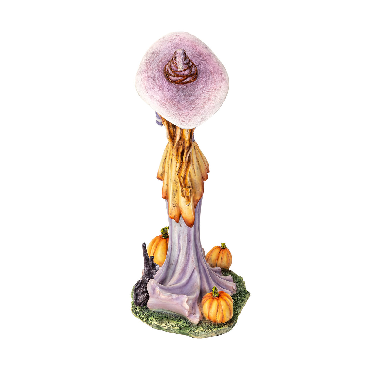 Figurine of a witch in pale purple and orange, holding up a pumpkin with more gourds at her feet and a black rabbit, shown from the back