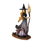Figurine of blond witch with broom, mushrooms at her feet