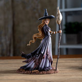 Figurine of blond witch with broom, mushrooms at her feet