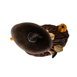 Figurine of witch with red hair, brown dress, surrounded by pumpkins, owl perched on her staff, shown top down